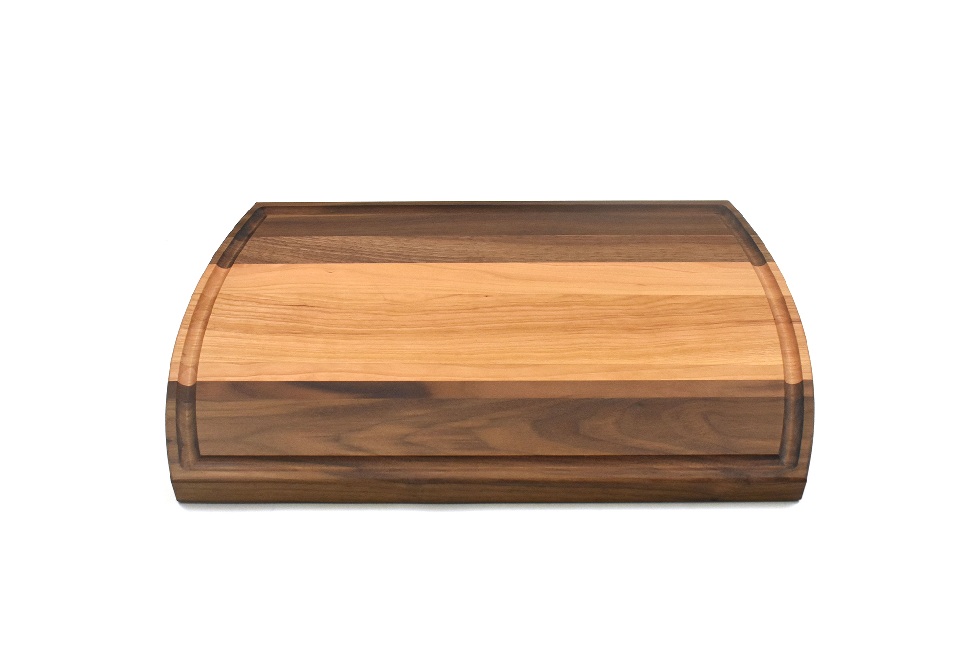 Large arched multi wood species cutting board with cherry in the middle