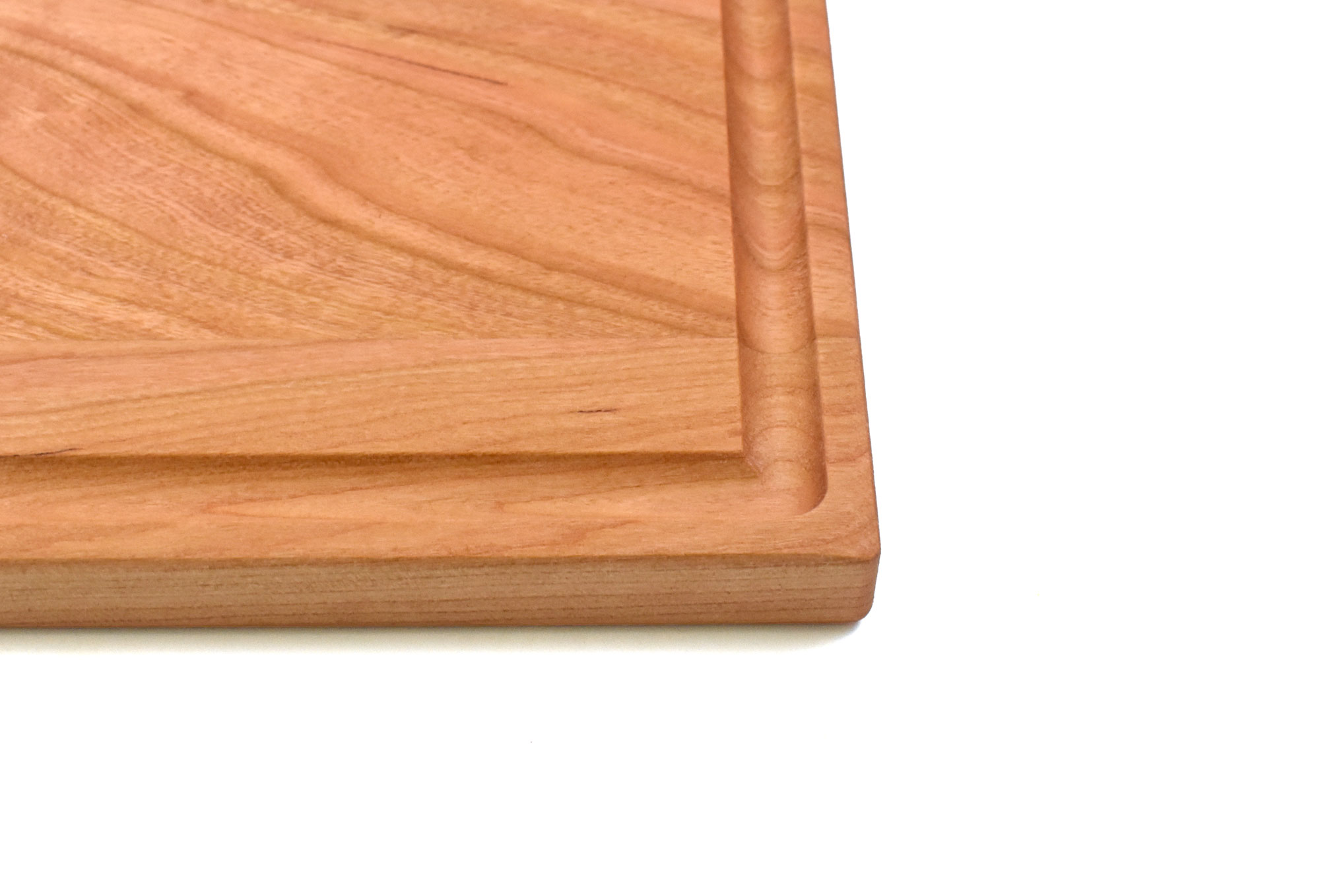 Small cherry board with rounded edges and juice groove